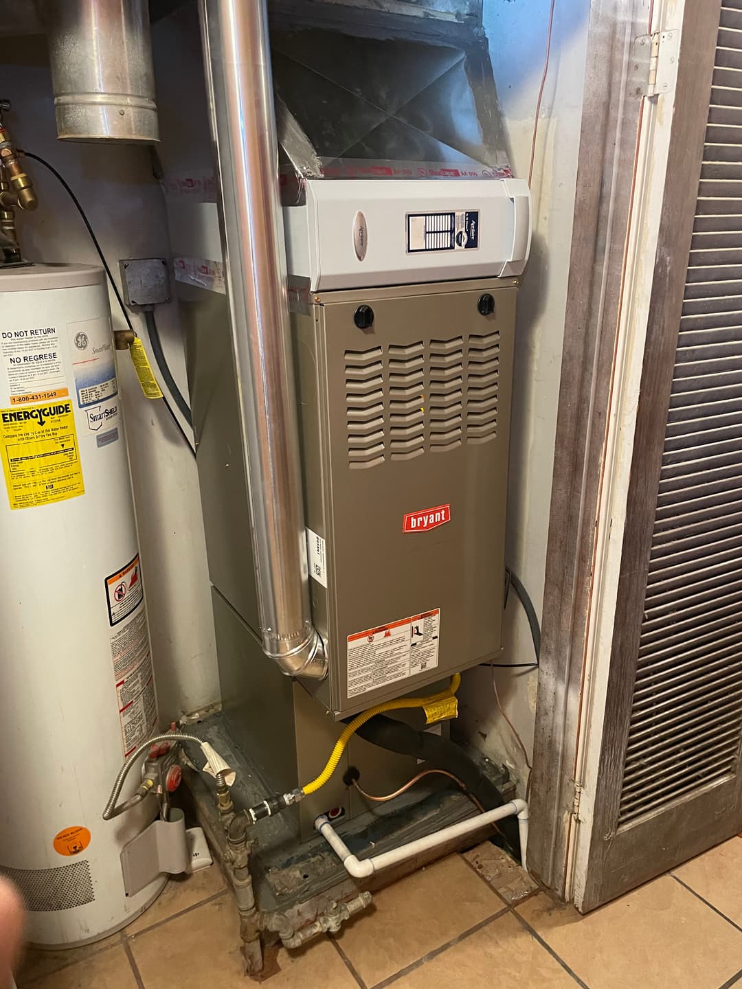 Bryant furnace installed in a residential setting next to a water heater.