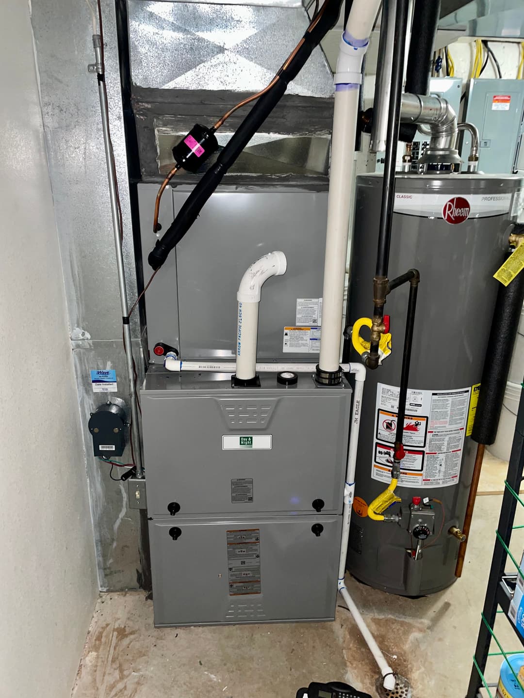 Modern heating system in a utility room with a furnace and water heater.